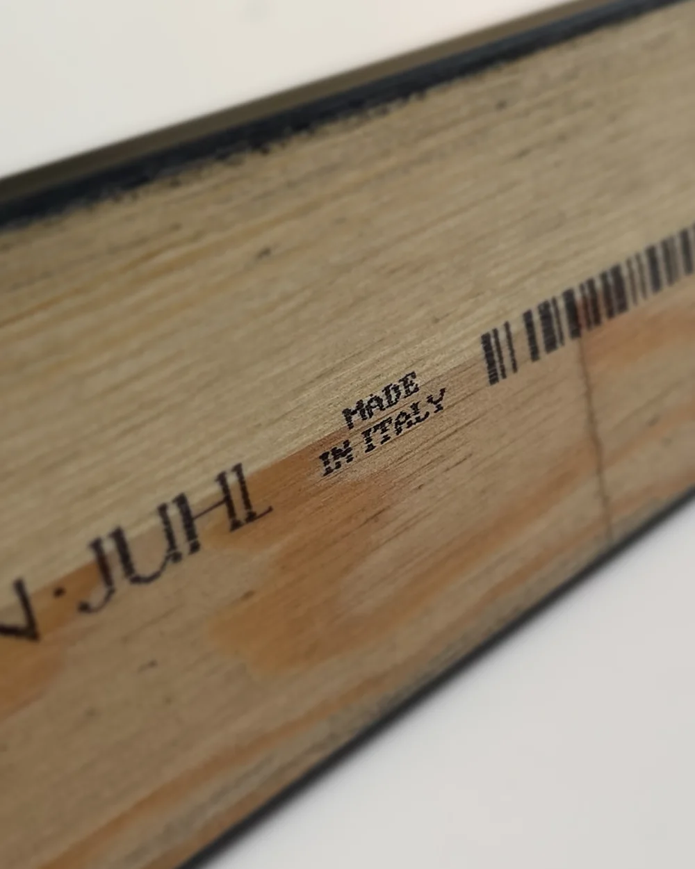 Close up of a solid wood frame moulding stamped Made in Italy