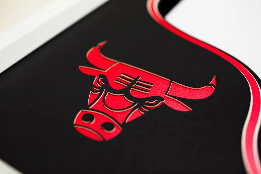A Chicago Bulls badge cut and layered from red and black mount board