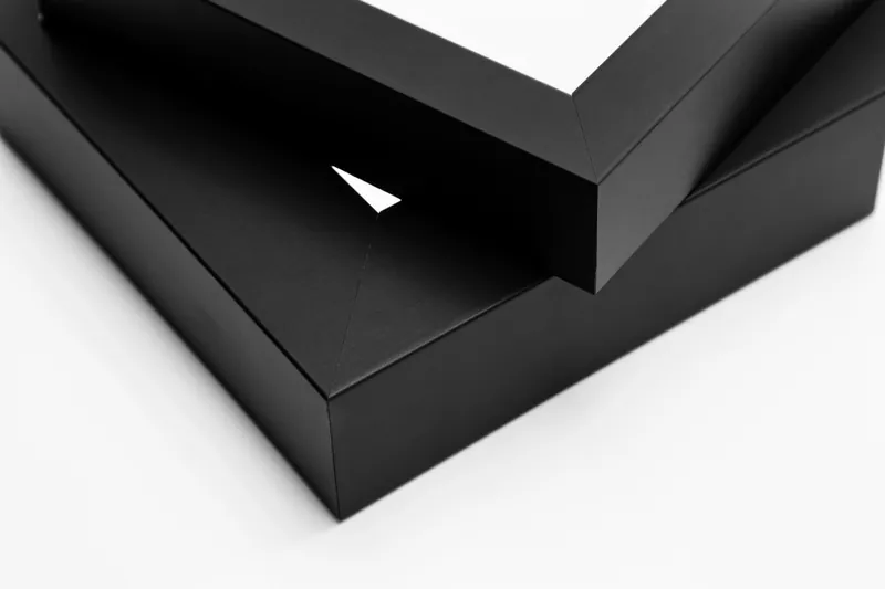 Close up of the slim Silver frame resting on the wide Gold one, showing their depth