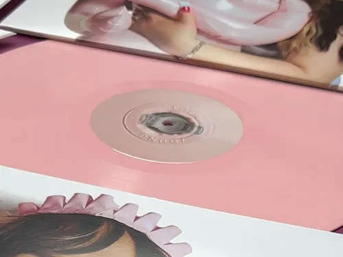 The pink vinyl in its cut-out below the sleeve