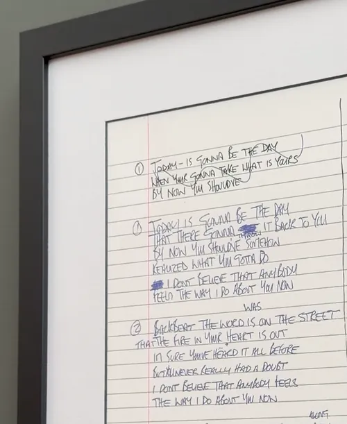 The top corner of the Oasis frame and the first lines of the handwritten lyrics