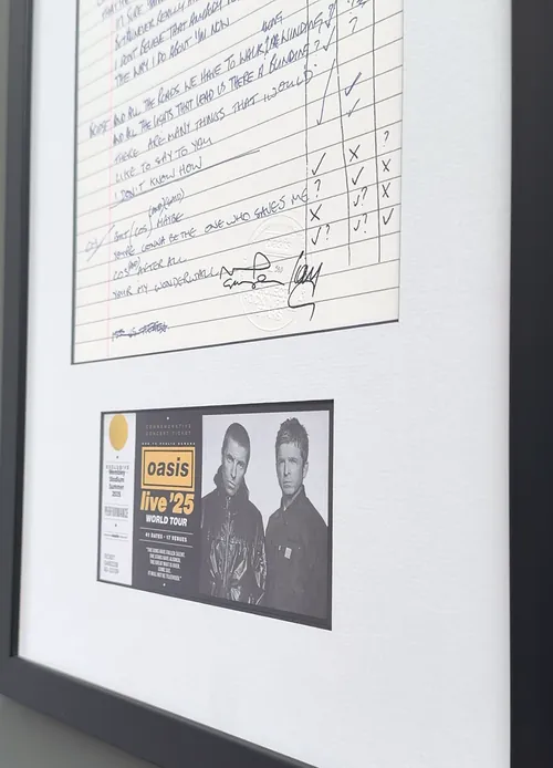 Close up of the signed lyric sheet and the Oasis Live '25 ticket