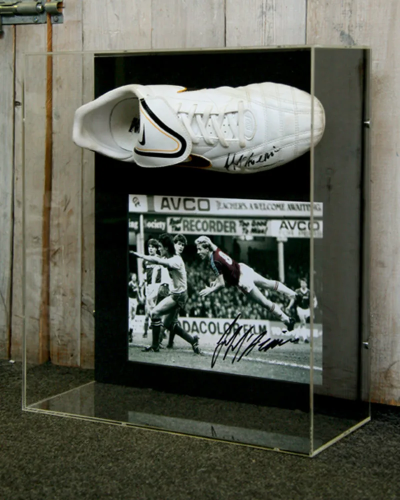 Signed football boot displayed inside a clear acrylic Perspex box frame, viewable from every angle