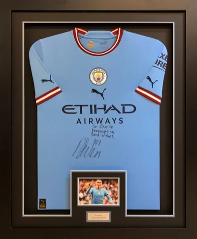 Framed signed Foden Manchester City football shirt with match images and engraved plaque