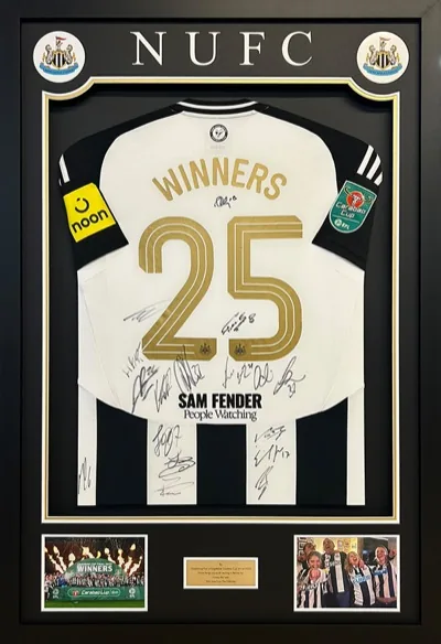 Framed Newcastle United football shirt with match images and engraved plaque